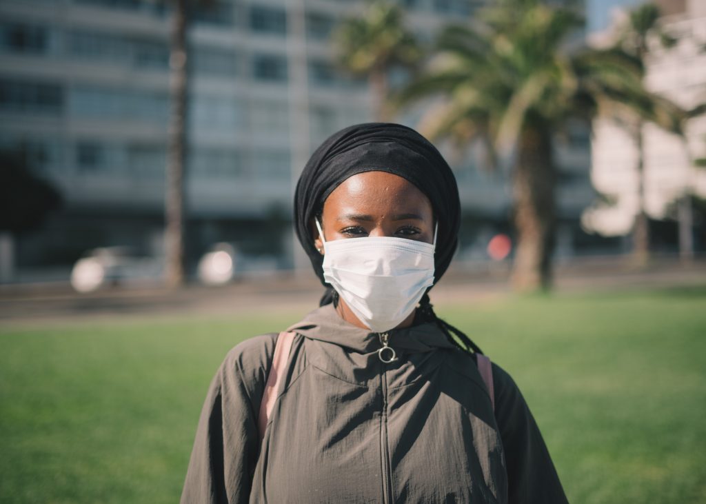 Woman wearing a facemask for blog by Metis HR on can I take employees off furlough