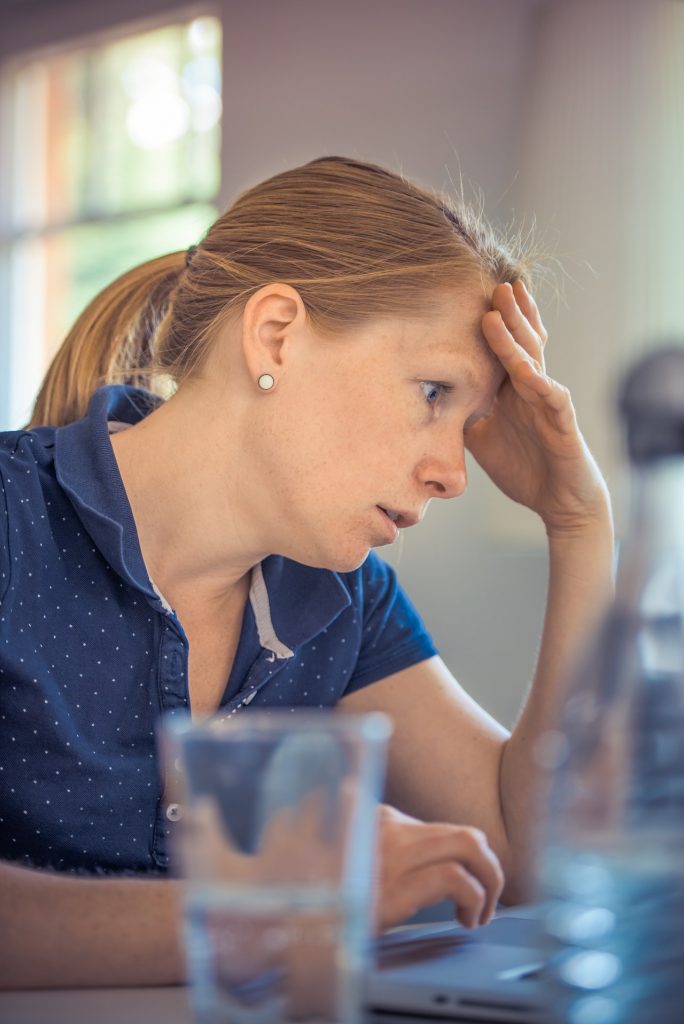 Image of a tired woman at work  for blog by Metis HR on working time regulations 