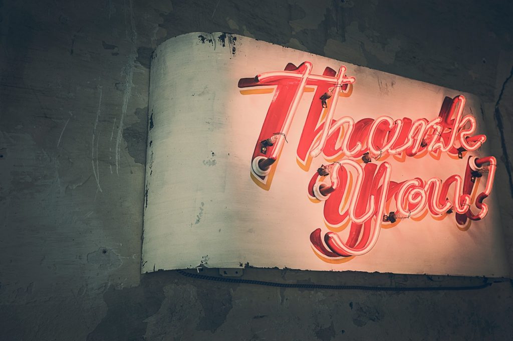 image of neon signs saying thank you for blog by Metis HR on employee rewards 