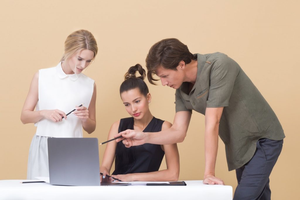 religious inclusivity at work being shown by group of people around a laptop
