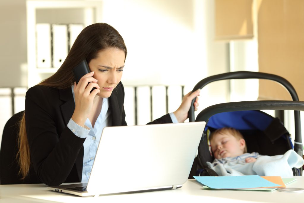 image of a working mother with her baby to depict What Not to Write in A Job Advertisement